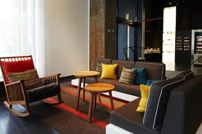 a living room with a couch and chairs and a table at Hôtel Alt Montréal in Montréal