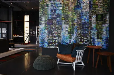 a room with a chair and a large painting on the wall at Hôtel Alt Montréal in Montréal