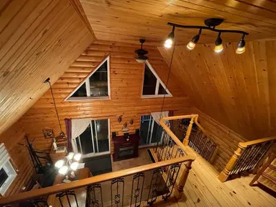 an overhead view of a cabin with wooden walls and ceilings at Chalets Garou in St-Ferdinand