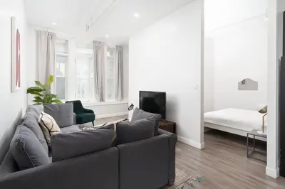 a living room with a couch and a bed at Boutique Lofts Notre Dame - Vieux Montréal in Montréal