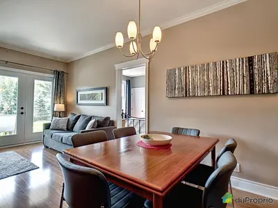 a living room with a table and a couch at Condo Le Champlain - 105 in Bromont