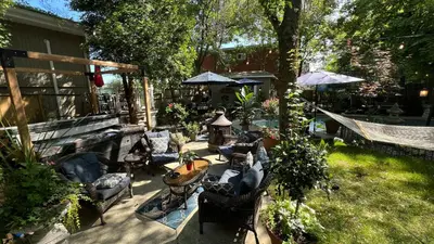 a patio with couches and a table and chairs at Gîte du Caméléon in Sherbrooke