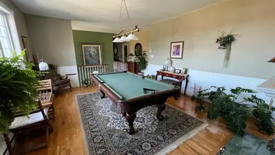 a living room with a pool table in it at Gîte du Caméléon in Sherbrooke