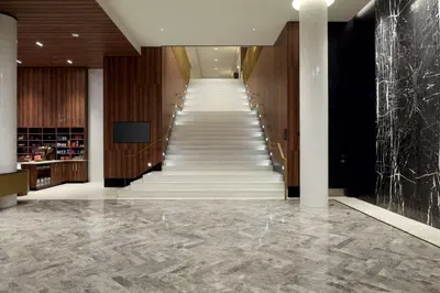 a staircase in a hotel lobby with marble floors at Hilton Garden Inn Montreal Midtown, Quebec, Canada in Montréal
