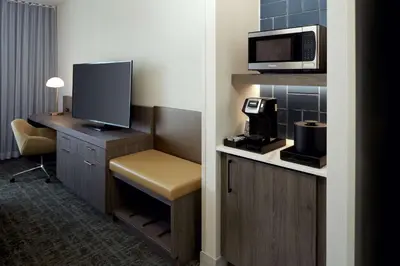 a hotel room with a television and a desk with a microwave at Hilton Garden Inn Montreal Midtown, Quebec, Canada in Montréal
