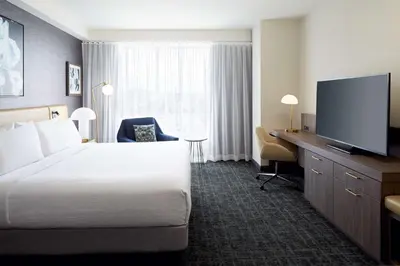 a hotel room with a bed and a flat screen tv at Hilton Garden Inn Montreal Midtown, Quebec, Canada in Montréal