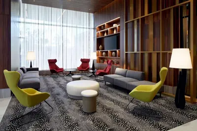 a living room with chairs and a couch and a table at Hilton Garden Inn Montreal Midtown, Quebec, Canada in Montréal