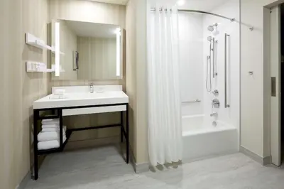 a bathroom with a sink and a shower and a tub at Homewood Suites By Hilton Montreal Midtown in Montréal