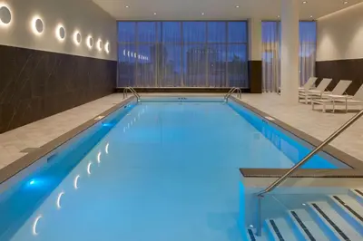 a large pool with blue water in a hotel room at Homewood Suites By Hilton Montreal Midtown in Montréal