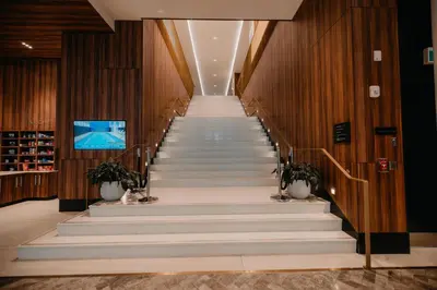 a staircase in a building with white marble steps at Homewood Suites By Hilton Montreal Midtown in Montréal