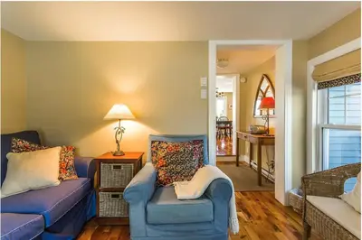 a living room with a blue couch and a chair at North House - Lovely Lac-Brome 3 Bedroom Lakefront Cottage in Lac-Brome