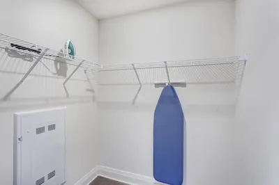 a blue tie hanging on a shelf in a room at L'Equinox Modern Apartments by Corporate Stays in Laval