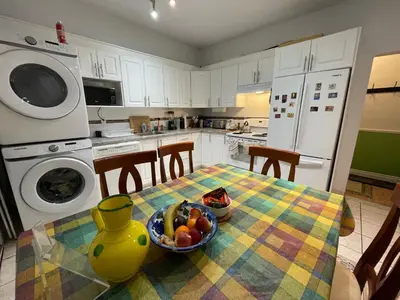 a kitchen with a table with a bowl of fruit on it at Chambres EL MEDITERRANEO Rooms in Montréal
