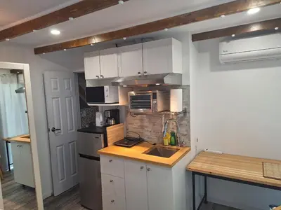 a kitchen with white cabinets and a counter top at Well Equipped Studio FOR NON-SMOKING GUESTS ONLY CITQ ЗO9467 in Longueuil