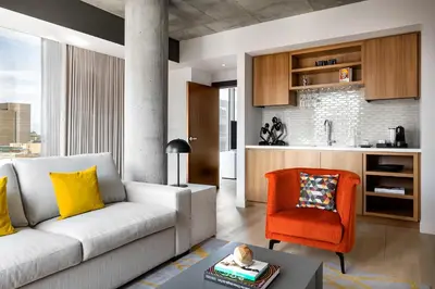 a living room with a couch and a chair at Humaniti Hotel Montreal, Autograph Collection in Montréal