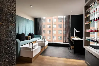 a room with a couch and a desk and a window at Humaniti Hotel Montreal, Autograph Collection in Montréal