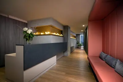 a lobby with red and black walls and a red couch at Humaniti Hotel Montreal, Autograph Collection in Montréal