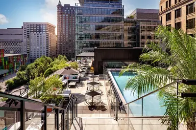 a balcony with a pool and a city skyline at Humaniti Hotel Montreal, Autograph Collection in Montréal