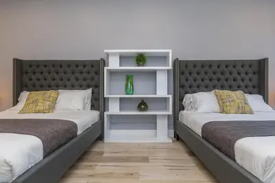 two beds sitting next to each other in a room at Lofts du Parc LaHaie in Montréal