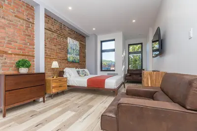 a living room with a bed and a couch at Lofts du Parc LaHaie in Montréal