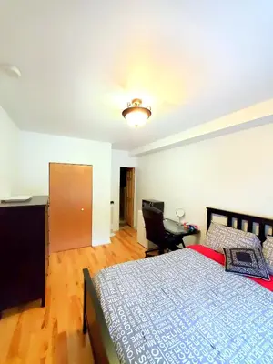 a bedroom with a bed and a desk and a chair at Maison Montplaisir in Montréal