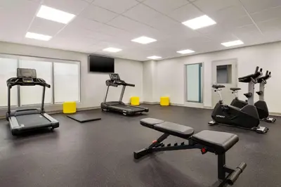 a gym with several treadmills and exercise bikes at Microtel Inn Suites by Wyndham Lac-Megantic in Lac-Mégantic