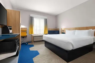 a hotel room with a bed and a television at Microtel Inn Suites by Wyndham Lac-Megantic in Lac-Mégantic