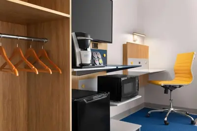 a room with a kitchen with a desk and a chair at Microtel Inn Suites by Wyndham Lac-Megantic in Lac-Mégantic