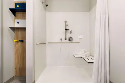 a bathroom with a shower with a shower curtain at Microtel Inn Suites by Wyndham Lac-Megantic in Lac-Mégantic