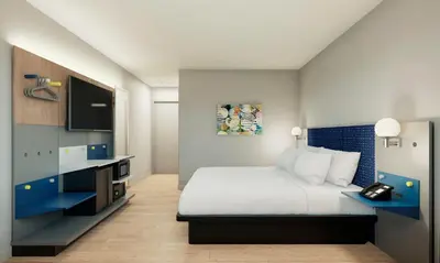 a bedroom with a large bed and a tv at Microtel Inn Suites by Wyndham Lac-Megantic in Lac-Mégantic