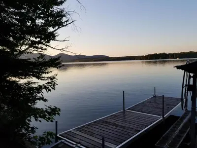 a dock in the middle of a lake at La Parade du Huard - Lac et Spa in Saint Sebastien