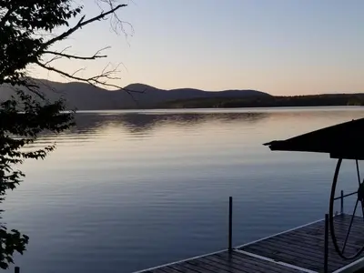 a view of a lake with a dock at La Parade du Huard - Lac et Spa in Saint Sebastien