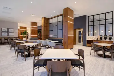 a restaurant with tables and chairs in a room at Hampton Inn Montreal Downtown, Qc in Montréal
