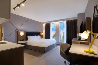 a hotel room with a bed and a desk at Hampton Inn Montreal Downtown, Qc in Montréal