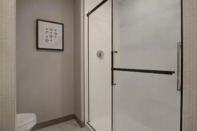 a shower stall in a bathroom with a toilet at Hampton Inn Montreal Downtown, Qc in Montréal