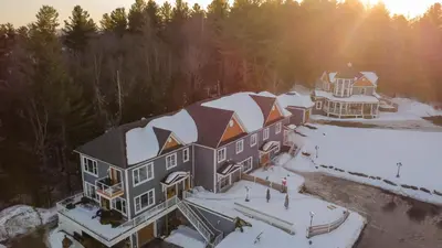 an aerial view of a house covered in snow at Au Sommet du Lac Magog in Magog-Orford