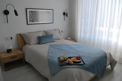 a bedroom with a bed with a tray of food on it at Plaza10 - 20 restaurants at under a 10 minute walk in Montréal
