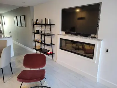 a living room with a fireplace with a flat screen tv at Plaza10 - 20 restaurants at under a 10 minute walk in Montréal