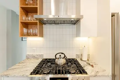 a tea kettle sitting on top of a stove in a kitchen at Plaza10 - 20 restaurants at under a 10 minute walk in Montréal