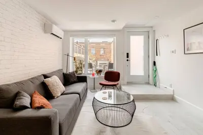 a living room with a couch and a table at Plaza10 - 20 restaurants at under a 10 minute walk in Montréal