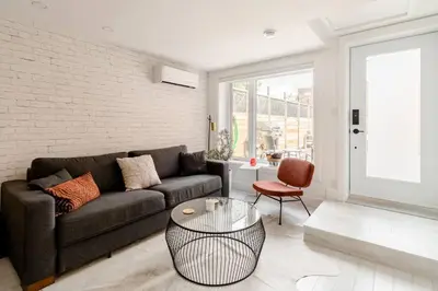 a living room with a couch and a table at Plaza10 - 20 restaurants at under a 10 minute walk in Montréal