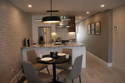 a dining room and kitchen with a table and chairs at Plaza10 - 20 restaurants at under a 10 minute walk in Montréal