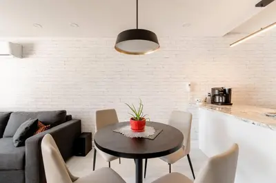 a living room with a table and a couch at Plaza12 - StringLights, XL Terrace, restos & shops in Montréal