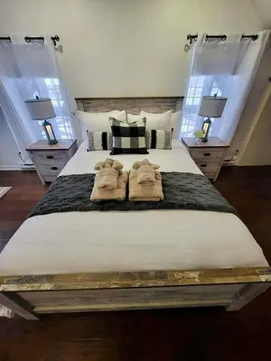 a bedroom with a large bed with two robes on it at Condo Hôtel Magog Orford in Orford