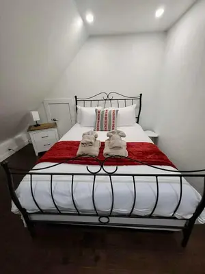 a bedroom with a bed with two towels on it at Condo Hôtel Magog Orford in Orford