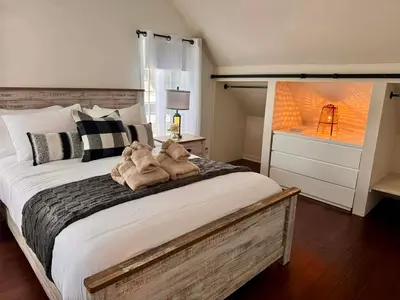 a bedroom with a large bed with two stuffed animals on it at Condo Hôtel Magog Orford in Orford