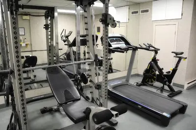 a gym with two exercise bikes and a treadmill at Condos Memphrémagog in Magog-Orford