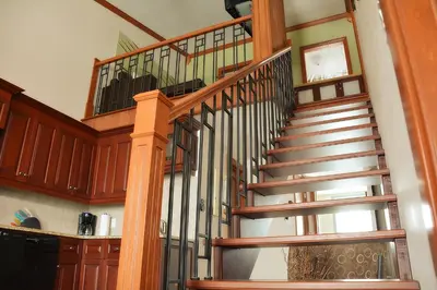 a spiral staircase in a home with wooden railings at Condos Memphrémagog in Magog-Orford