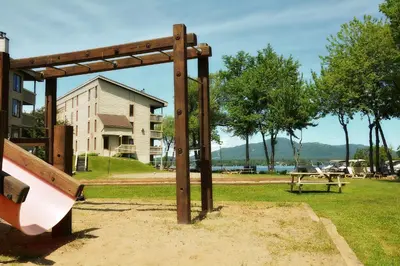 a park with a bench and a picnic table at Condos Memphrémagog in Magog-Orford