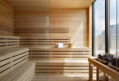 a sauna with wooden walls and a glass wall at Hyatt Place Montreal - Downtown in Montréal